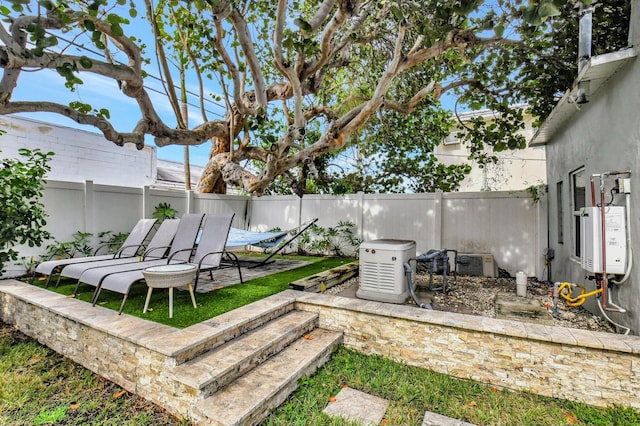 view of yard with a patio area and water heater