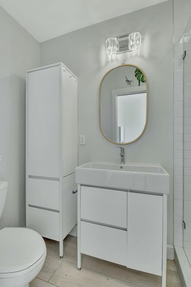 bathroom featuring tile patterned flooring, vanity, and toilet