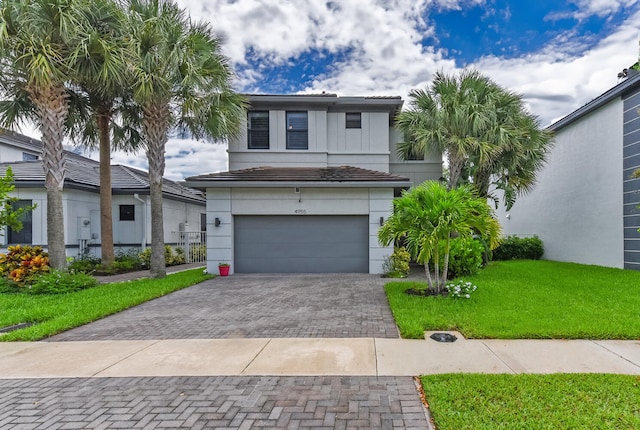 view of front of home featuring a front yard and a garage