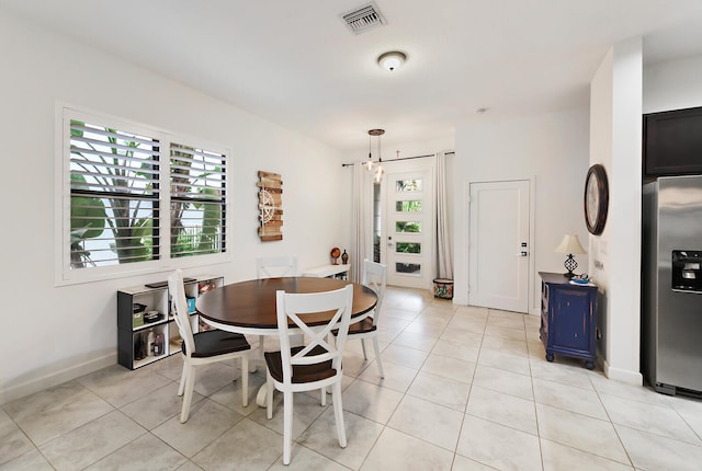 tiled dining room featuring plenty of natural light