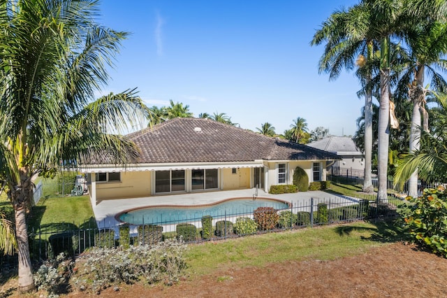 view of pool with a lawn and a patio