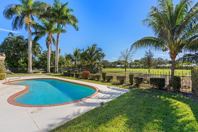 view of pool featuring a lawn