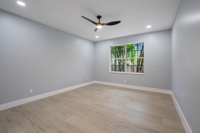 unfurnished room with ceiling fan and light wood-type flooring