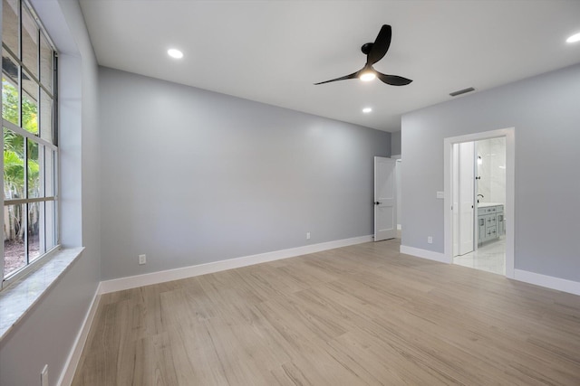 unfurnished room with light hardwood / wood-style floors, ceiling fan, and a healthy amount of sunlight