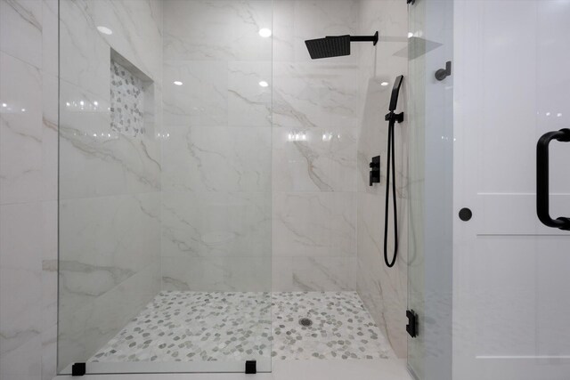 bathroom with a shower with shower door