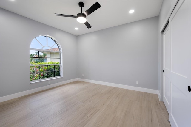 spare room with ceiling fan and light hardwood / wood-style flooring