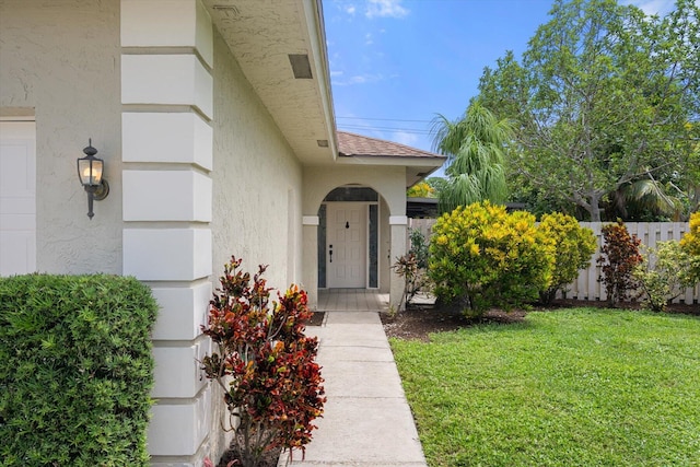 property entrance with a yard