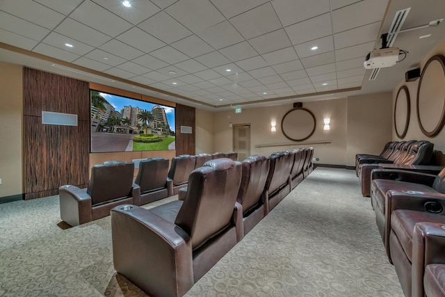 home theater room with light carpet and a tray ceiling