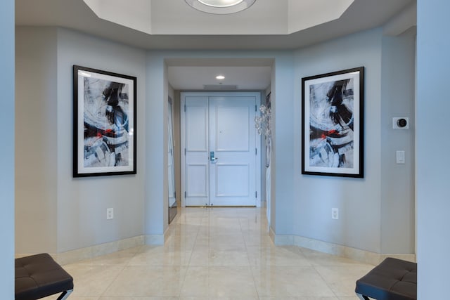 hallway with a tray ceiling