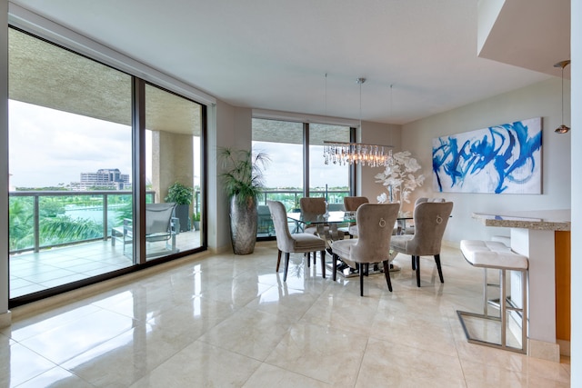 dining room featuring expansive windows and a chandelier