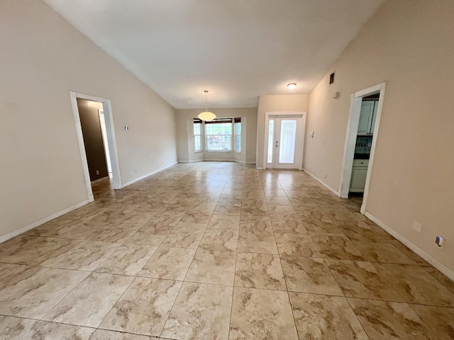 spare room featuring vaulted ceiling