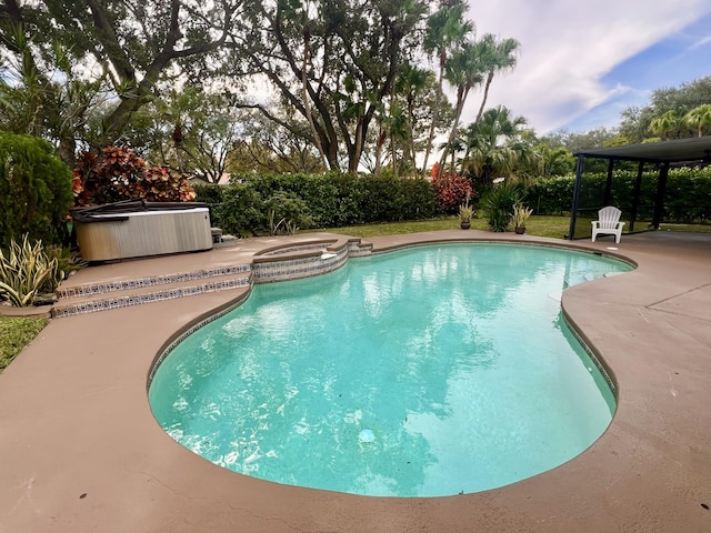 view of pool with an outdoor hot tub and a patio