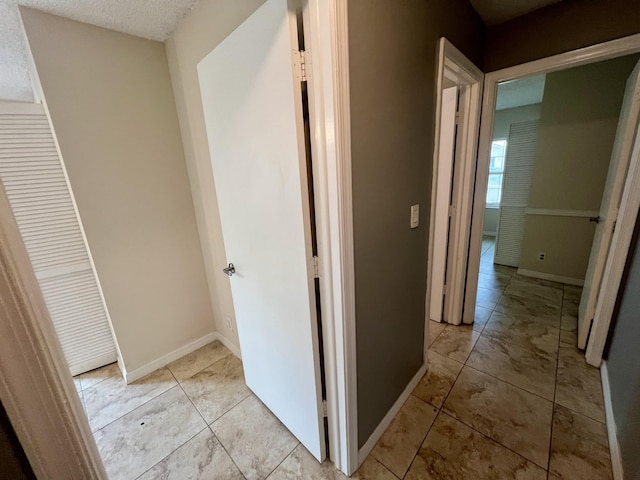 corridor with a textured ceiling