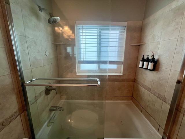 bathroom with shower / bath combination with glass door