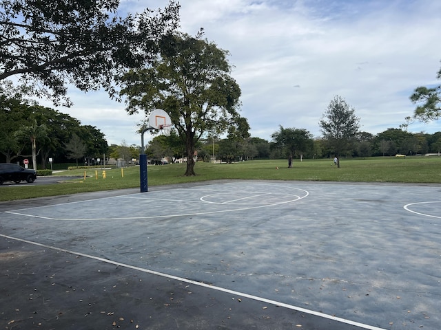 view of sport court with a lawn