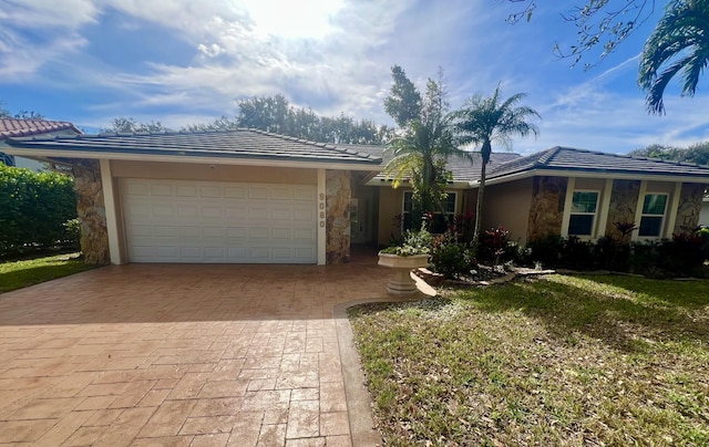 ranch-style home with a front yard and a garage