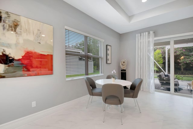 dining area featuring a tray ceiling