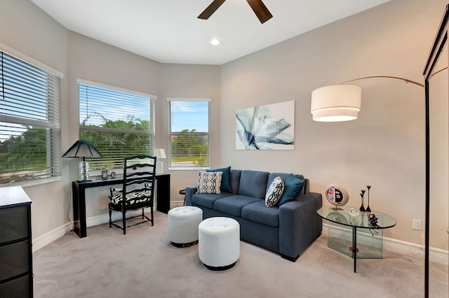 living room featuring light carpet and ceiling fan