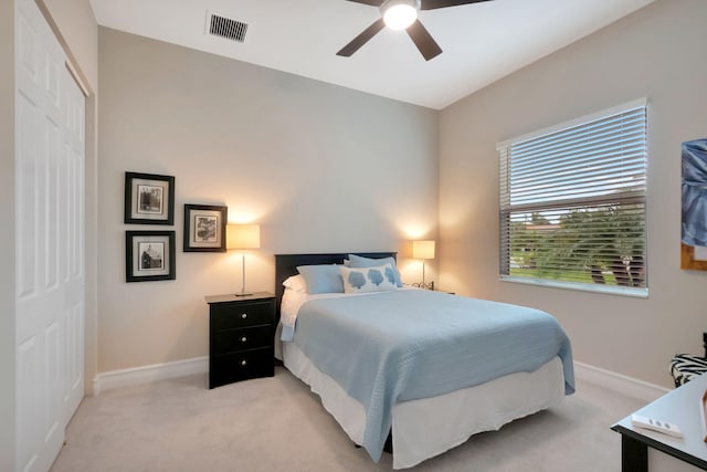 carpeted bedroom with a closet and ceiling fan