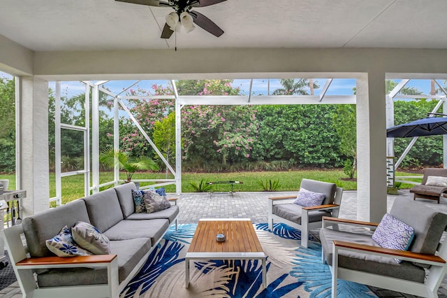 view of patio / terrace with an outdoor hangout area, glass enclosure, and ceiling fan