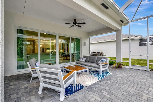 view of patio / terrace with a lanai, outdoor lounge area, and ceiling fan