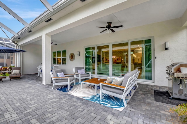 view of patio / terrace with a lanai, grilling area, ceiling fan, and an outdoor hangout area