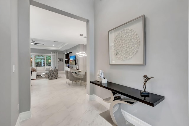 hallway with a raised ceiling