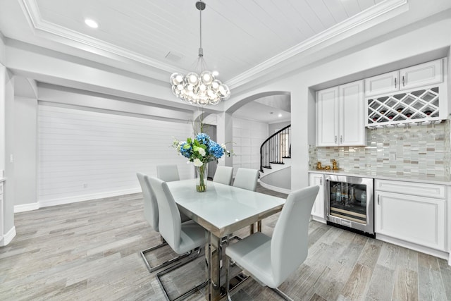 dining room featuring wooden ceiling, beverage cooler, indoor bar, and light wood-type flooring