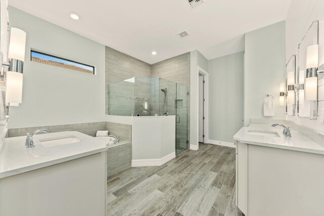 bathroom featuring a shower, wood-type flooring, vanity, and wood walls