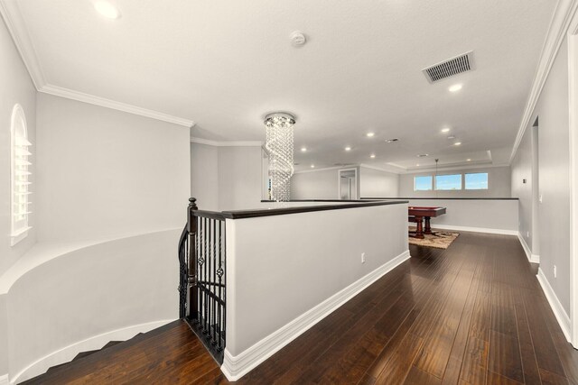 hallway with crown molding and dark hardwood / wood-style floors