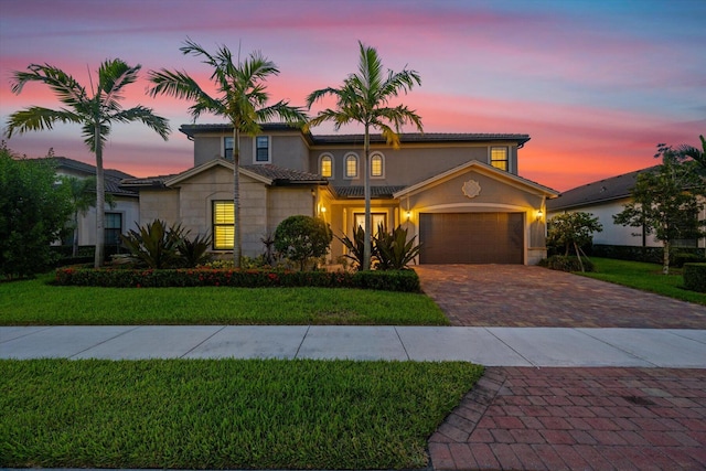 view of front of house featuring a garage and a yard