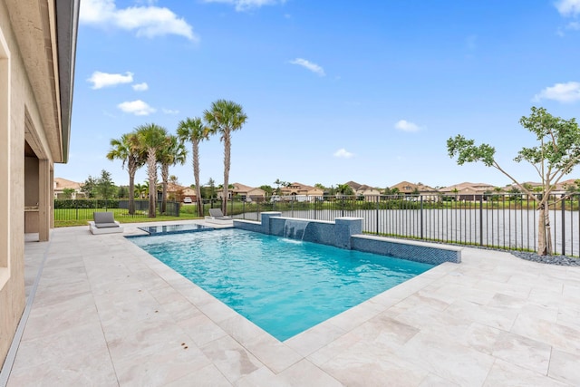 view of pool with pool water feature, a patio area, and a water view