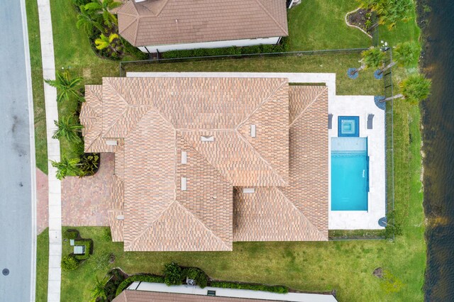 view of swimming pool featuring a yard, an outdoor hangout area, a water view, and a patio area