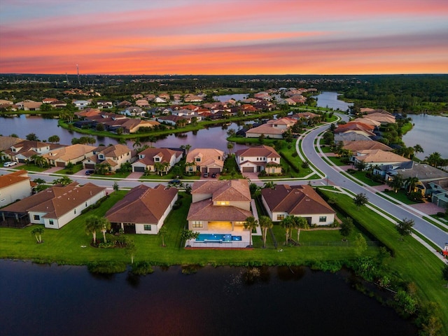 aerial view at dusk with a water view