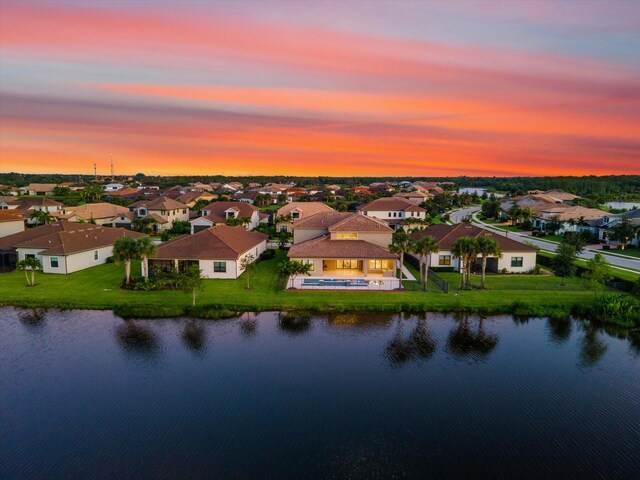 back of property featuring a swimming pool with hot tub, an outdoor hangout area, a patio area, and exterior kitchen