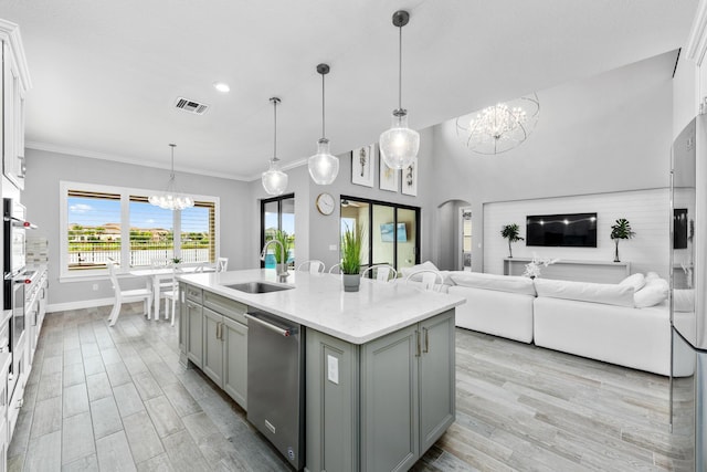 kitchen featuring gray cabinetry, a kitchen island with sink, sink, and white cabinets