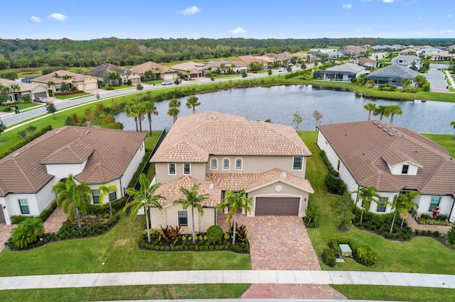 birds eye view of property with a water view