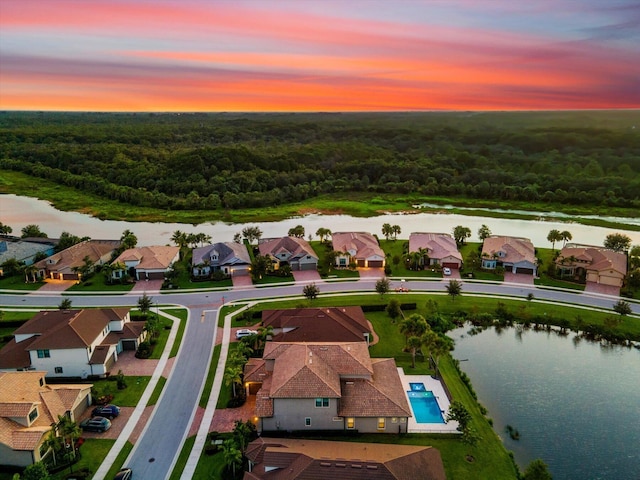 aerial view at dusk with a water view