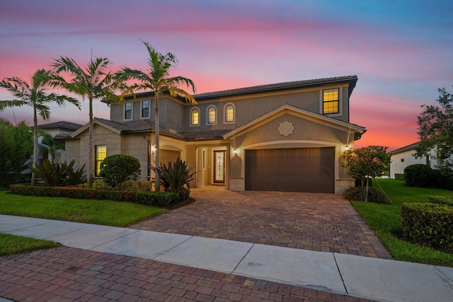 view of front of house with a yard and a garage