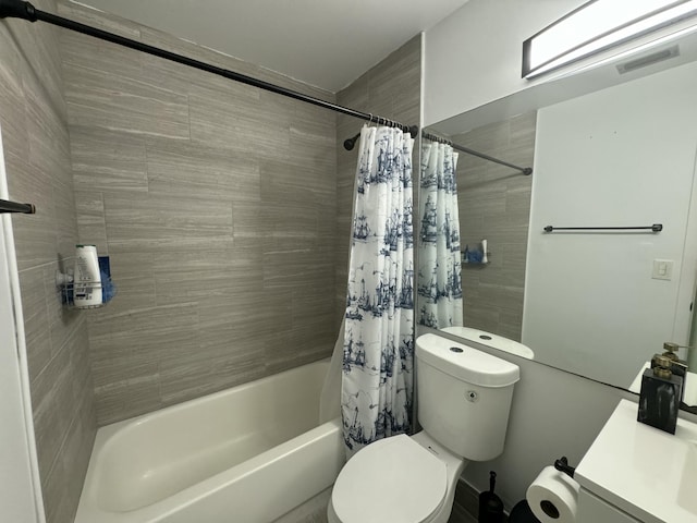 full bathroom featuring vanity, shower / tub combo, and toilet