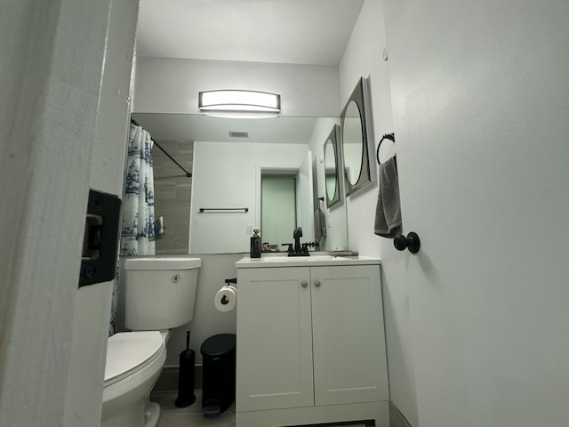 bathroom featuring vanity, curtained shower, and toilet