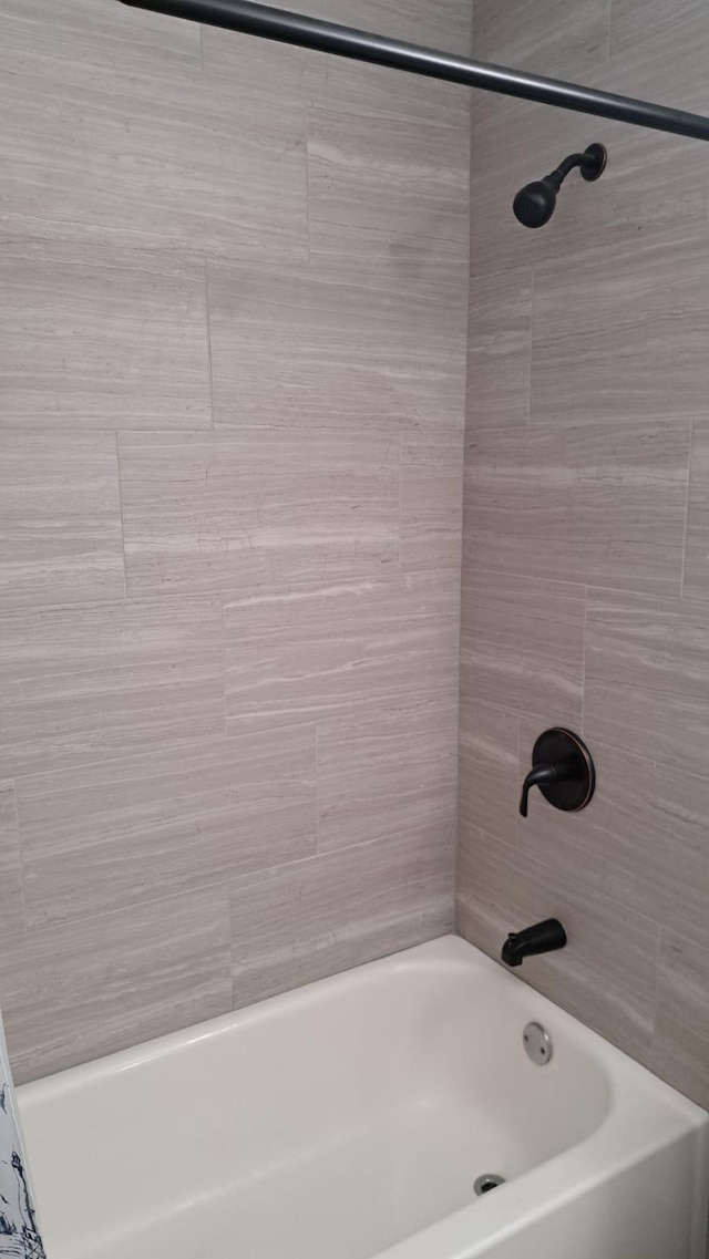 bathroom with tiled shower / bath combo