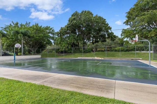 view of basketball court with a yard