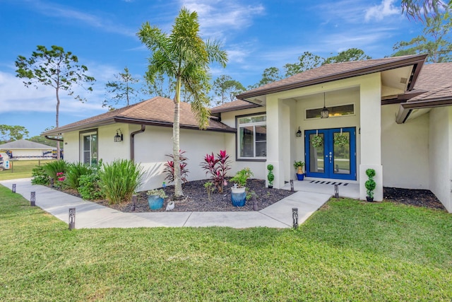 exterior space with french doors and a front lawn