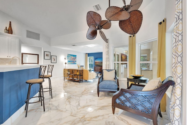 interior space featuring ceiling fan and plenty of natural light