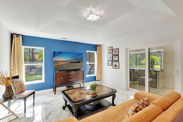 living room featuring a tray ceiling