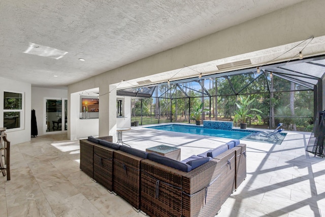 view of pool with pool water feature, a patio area, and a lanai