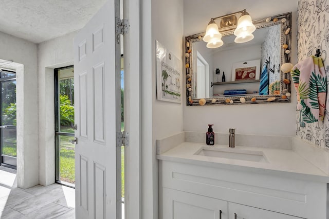 bathroom with vanity and a textured ceiling