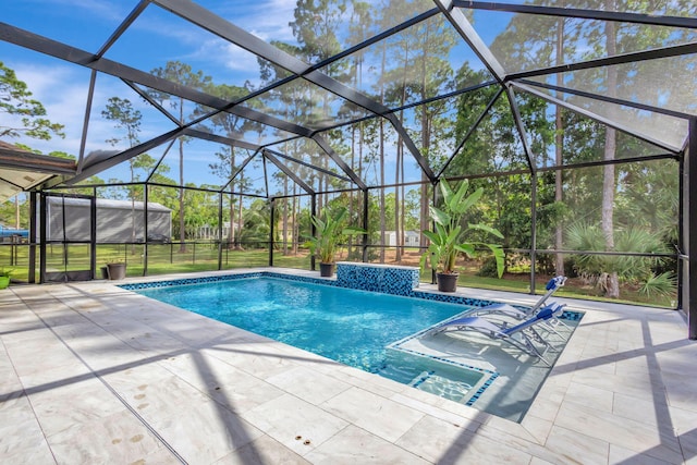 view of swimming pool featuring glass enclosure and a patio area