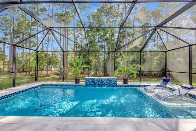 view of swimming pool with a lanai, pool water feature, and a patio